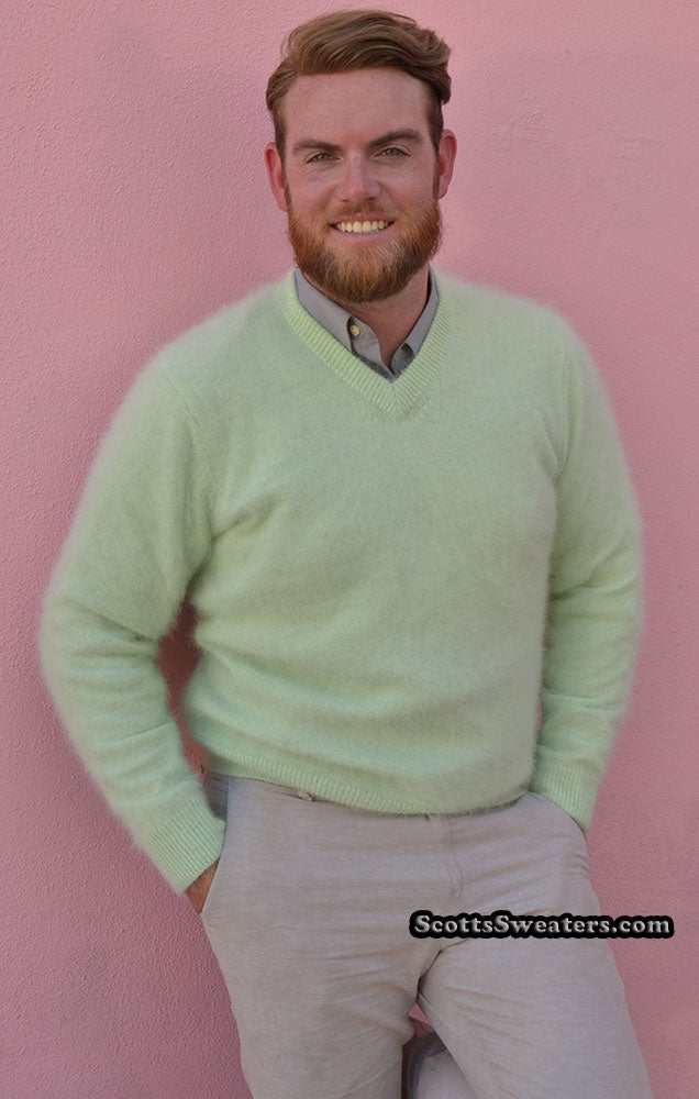 Man wearing a light green men's ultra-soft angora V-neck sweater against a pink background