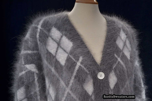 Woman's super-soft grey and white argyle angora cardigan sweater with button front on mannequin