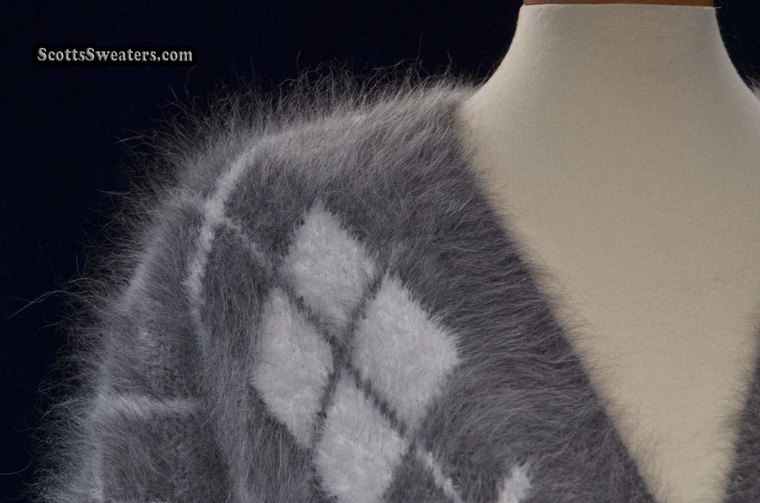 Woman's super-soft grey and white argyle angora cardigan sweater on mannequin