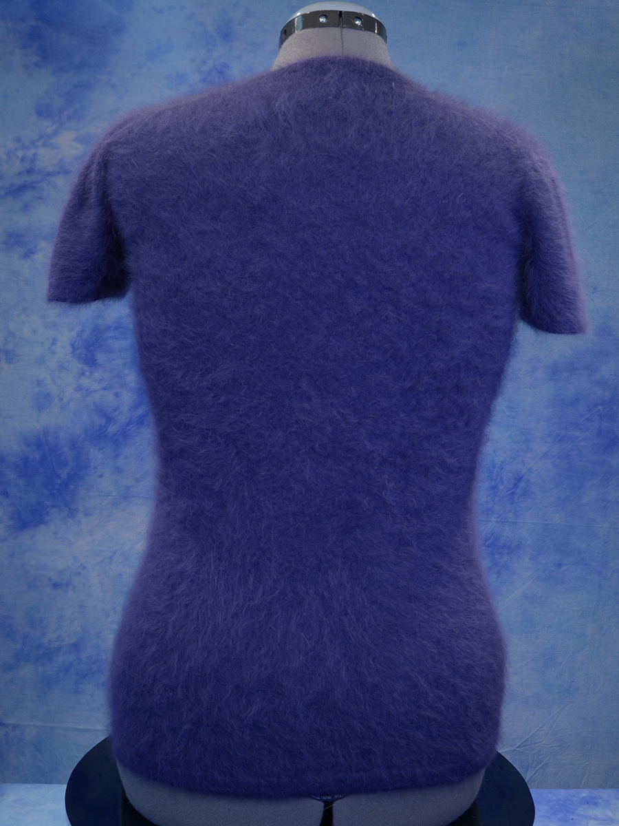 Girl's dusty-purple short-sleeved angora sweater by Sister Sibling displayed on a mannequin against a blue background
