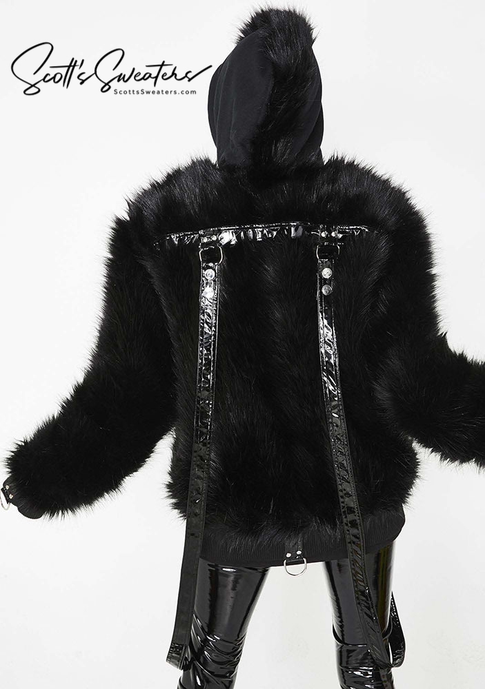 Punk style thick and fluffy black faux-fur jacket with zipper front, hood, hanging straps, and metal D-rings on cuffs.