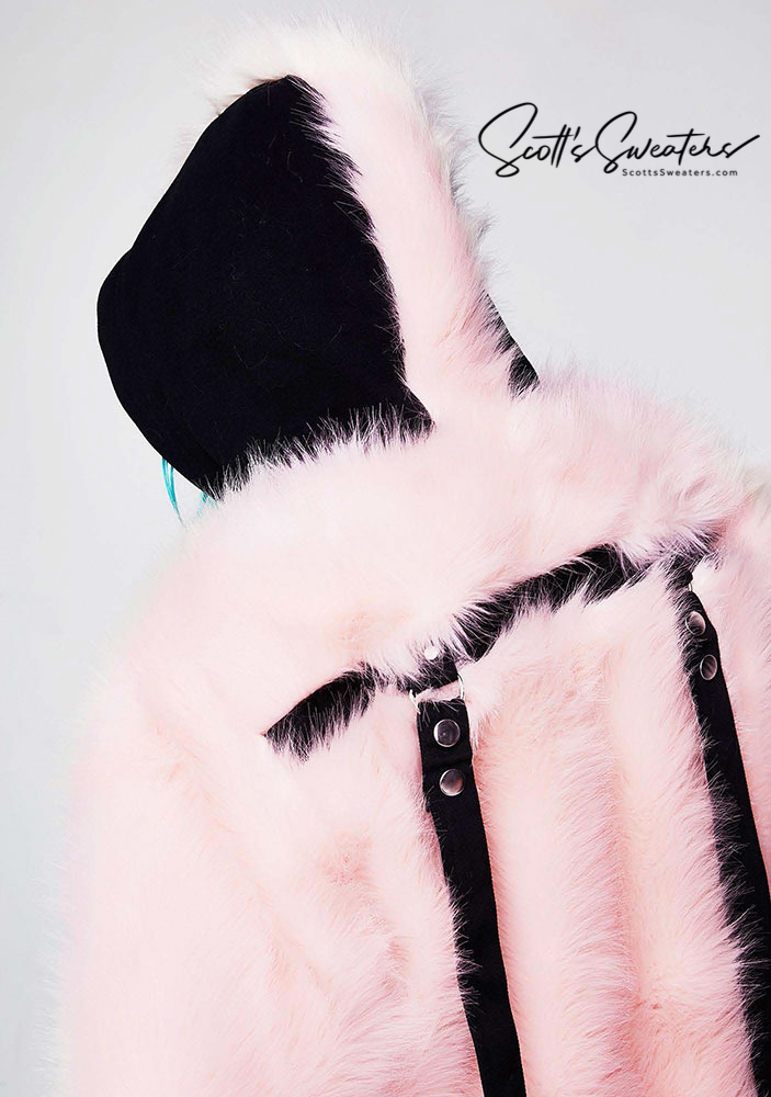 Punk style thick fluffy light pink faux-fur jacket with black hood, hanging straps, and metal D-rings on cuffs.