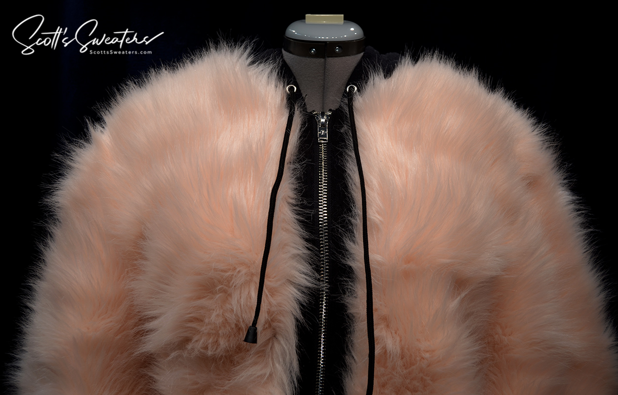 Punk style thick fluffy faux-fur jacket with zipper front and hanging straps on cuffs in pale pink