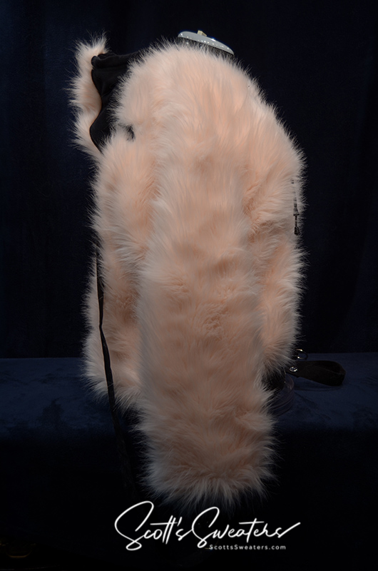 Punk style thick and fluffy faux-fur jacket with zipper front, hanging straps, and metal D-rings on cuffs, featuring a Mohawk hood design.