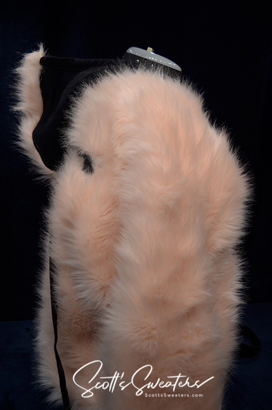 Punk style thick and fluffy faux-fur jacket with zipper front, hanging straps, metal D-rings, and Mohawk hood design.