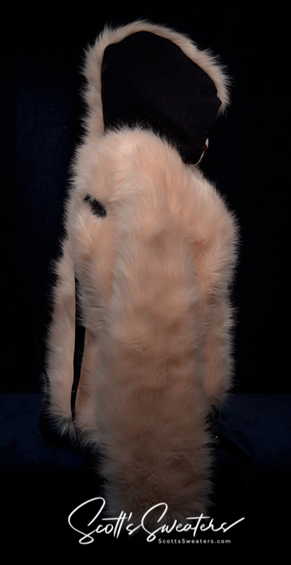 Punk style thick and fluffy faux-fur jacket with zipper front, hanging straps, metal D-rings on cuffs, and mohawk hood design