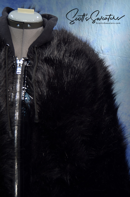Punk style thick and fluffy black faux-fur jacket with zipper front, hood, hanging straps, and metal D-rings on cuffs