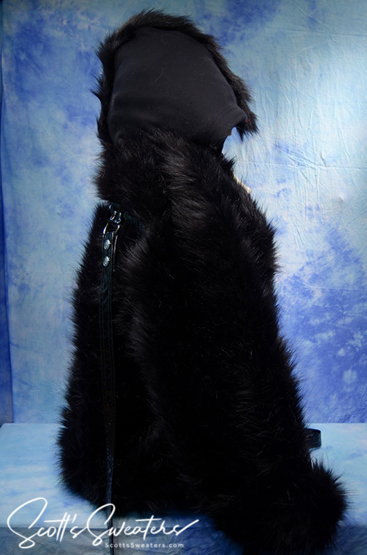Punk style thick fluffy black faux-fur jacket with zipper front, hanging straps, metal D-rings, and Mohawk hood design.