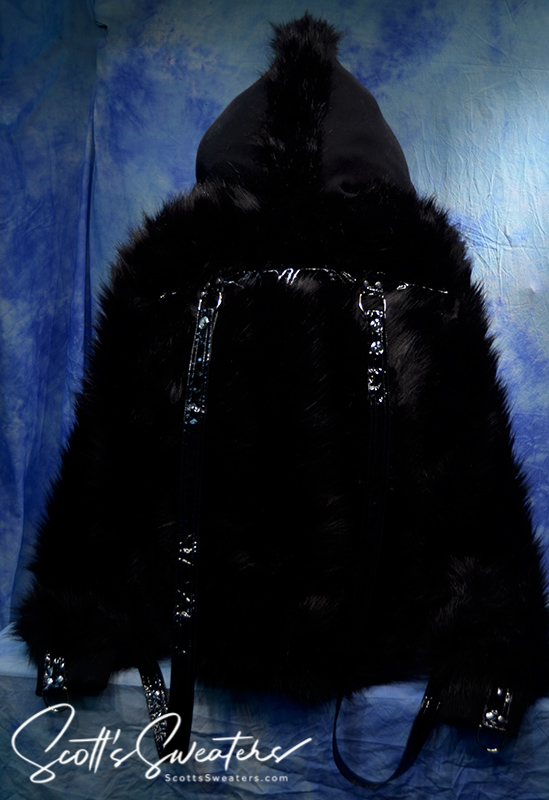 Punk style thick and fluffy black faux-fur jacket with zipper front, hooded mohawk design, hanging straps, and metal D-rings on cuffs