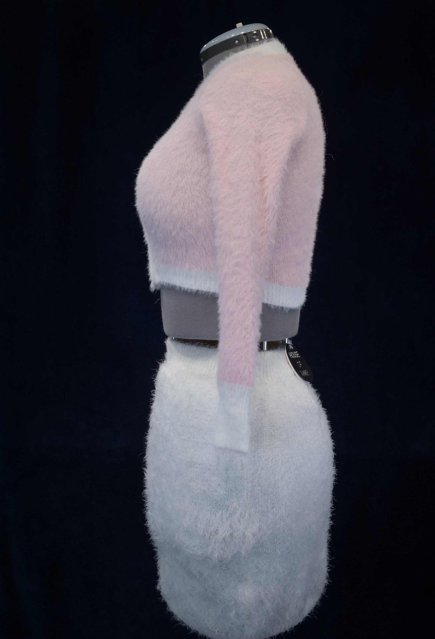 Soft and fuzzy pink plush girl's or woman's eyelash cardigan sweater on mannequin side view