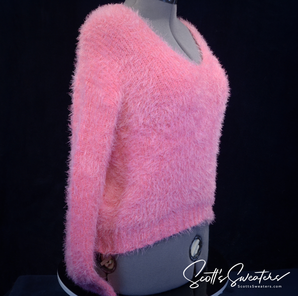 Woman's fuzzy hot-pink plush V-neck sweater on mannequin medium size