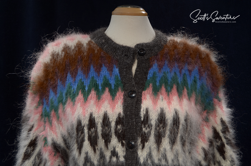 Woman's colorful ultra-soft alpaca cardigan sweater with multi-color ethnic stripes and wooden buttons on mannequin