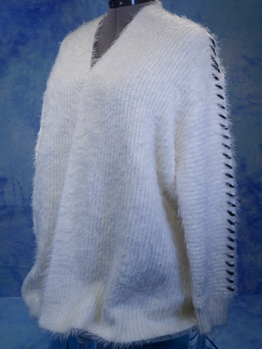Woman's white eyelash open-front cardigan sweater with black hash marks along sleeves