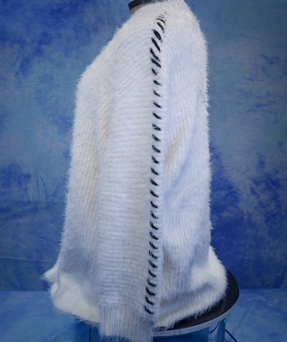 Woman's white eyelash open-front cardigan sweater with black hash mark stripes along sleeves