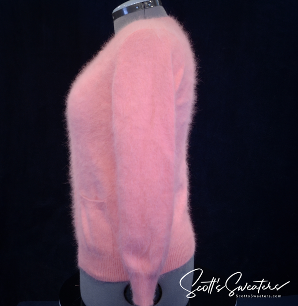 Women's pink angora cardigan sweater with chrome skull buttons