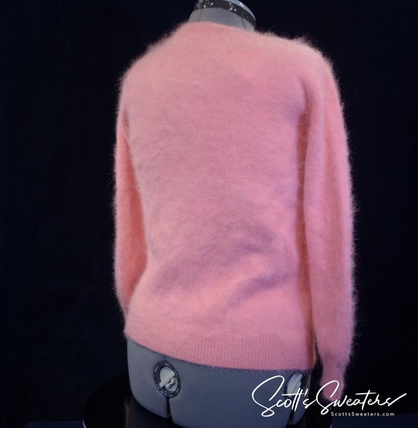 Women's pink angora cardigan sweater with chrome skull buttons