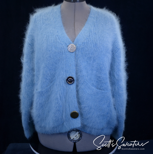 Woman's powder-blue angora cardigan sweater with oversized metal buttons and front pockets