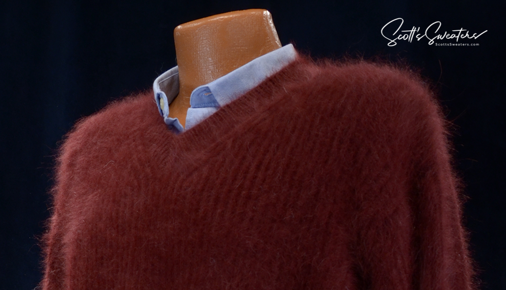 Men's soft luxurious angora sweater in deep red with rib-knit V-neck design on mannequin