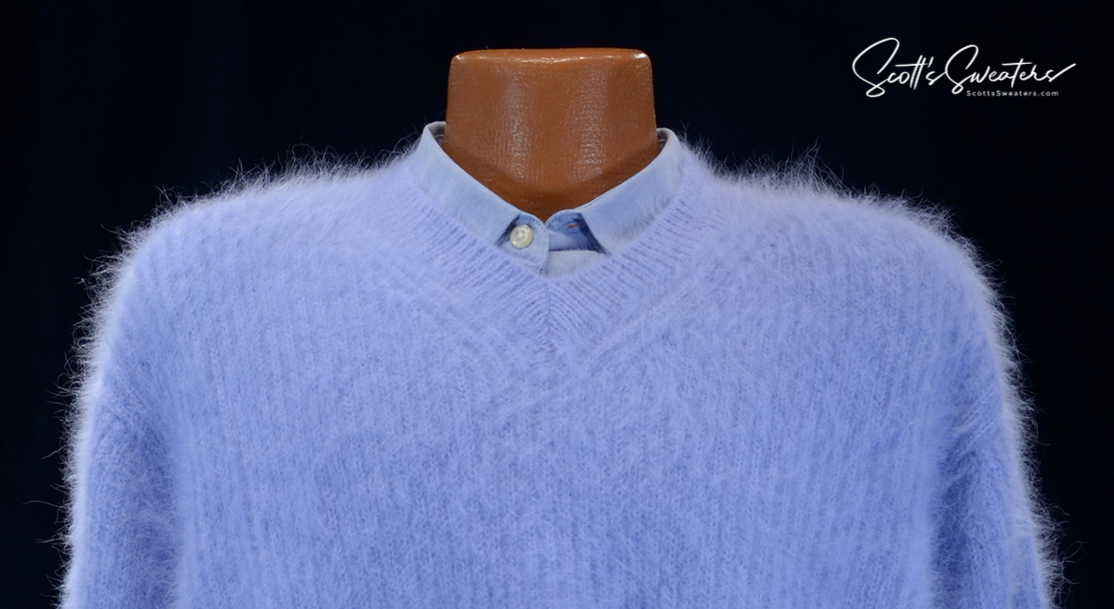 Men's soft luxurious light blue angora sweater with close-cut V-neck and rib-knit design on mannequin with buttoned shirt underneath