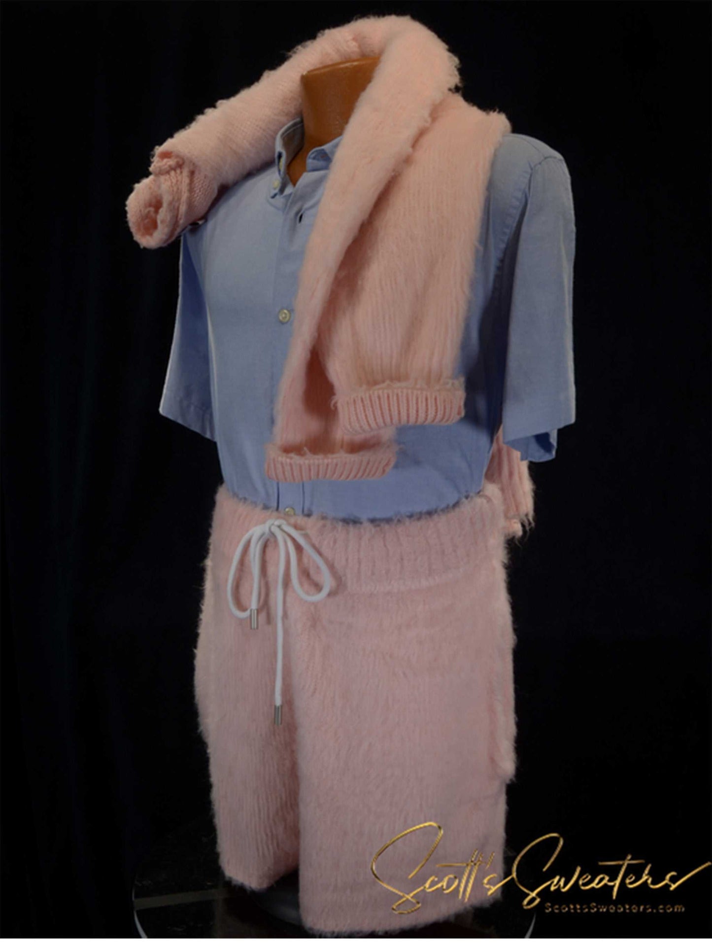 Men's fuzzy pink plush cardigan sweater with matching shorts outfit on mannequin