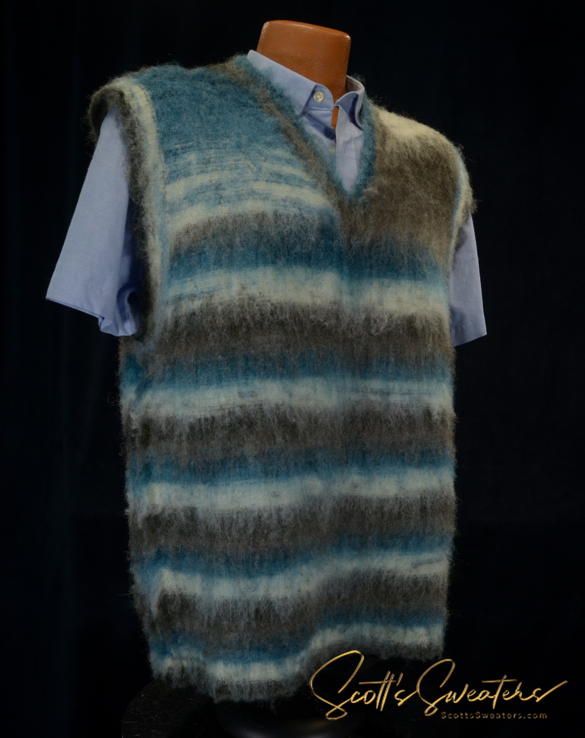Variegated colored mohair sleeveless men's vest in blue, grey, and white stripes over a light blue shirt on a mannequin