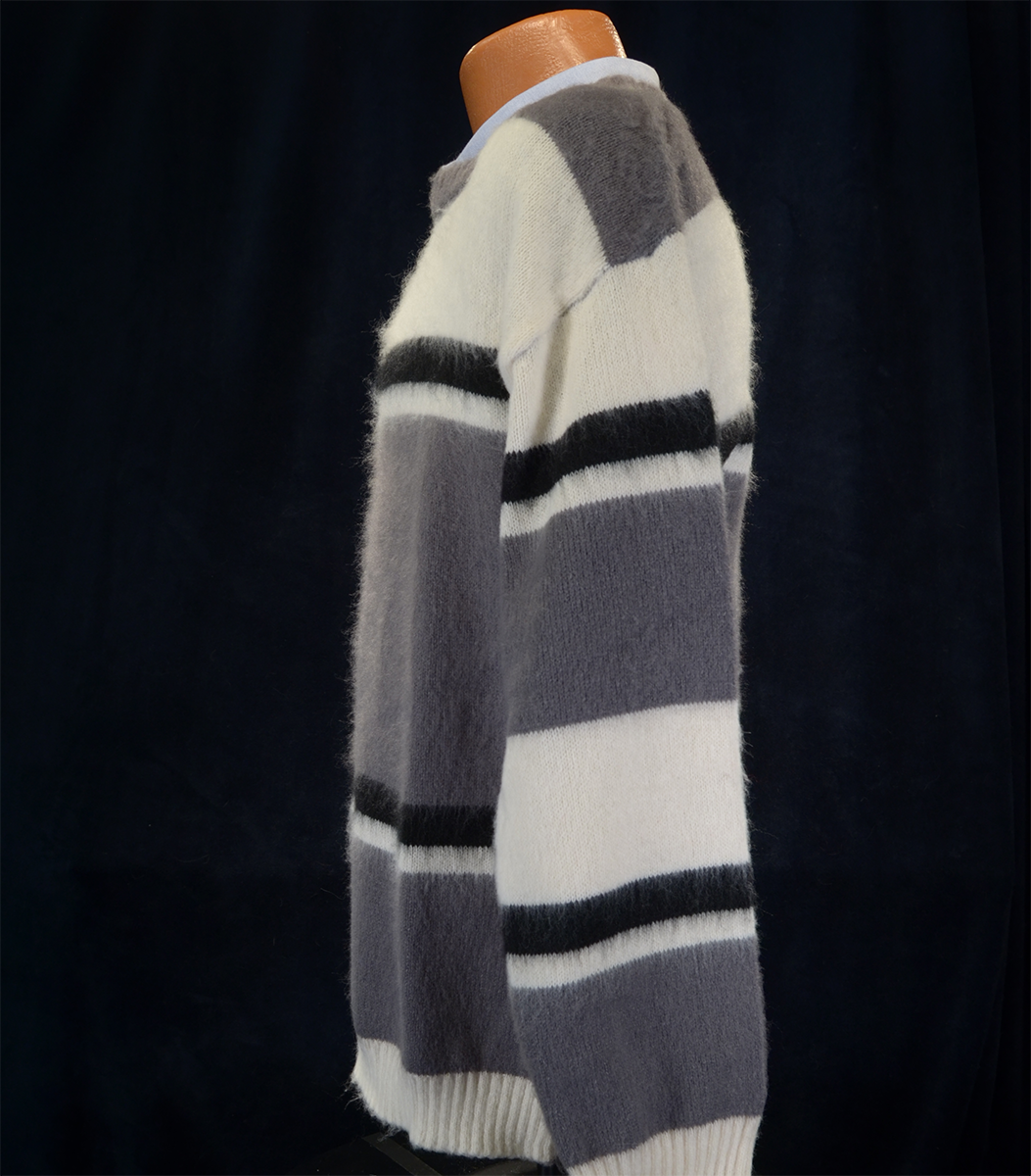 Men's striped fuzzy mohair crewneck sweater in grey, white, and black stripes on mannequin against black background