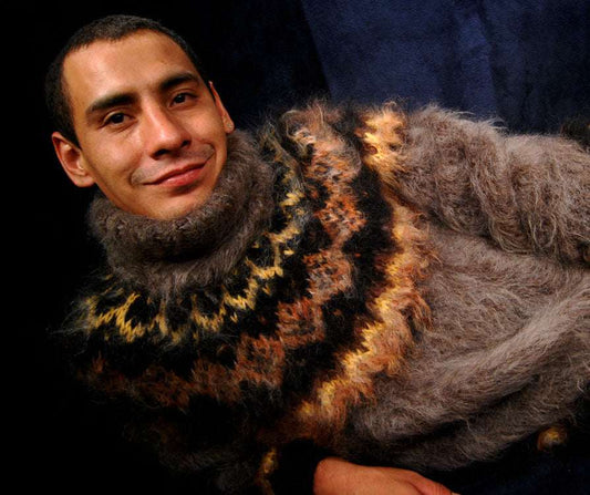 Man wearing a luxurious handknit mink-colored mohair turtleneck sweater with patterned yoke design