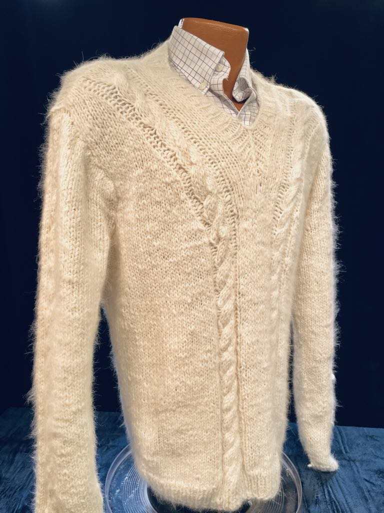 Men's home-spun angora-silk cream sweater with cable knit pattern on mannequin
