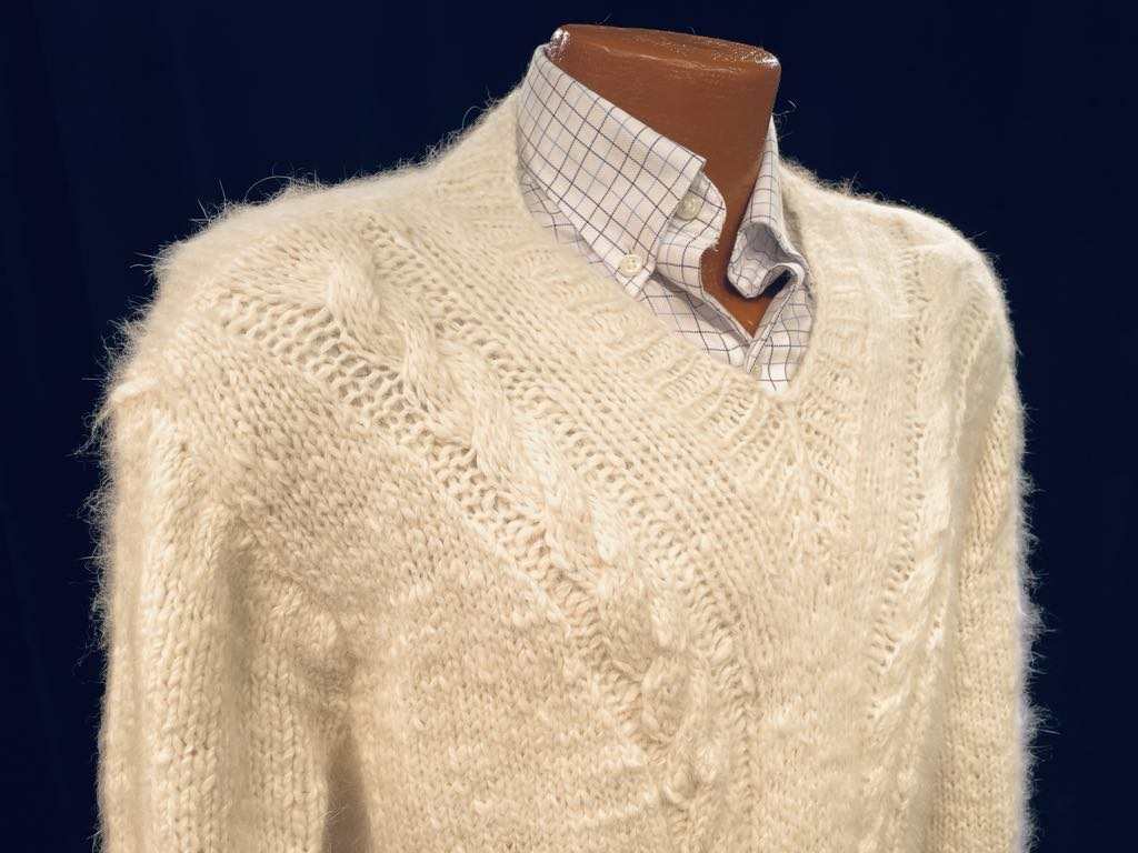 Men's home-spun angora-silk hand-knit cream cable-knit sweater on mannequin with checkered shirt