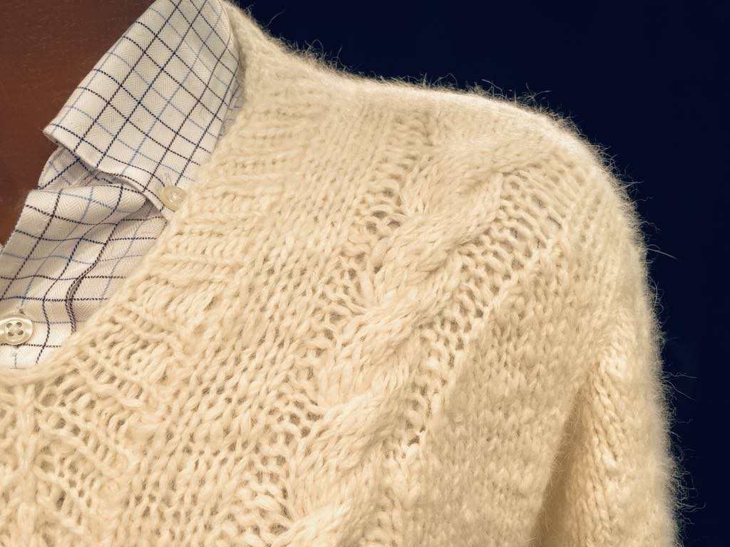 Men's home-spun angora-silk sweater in cream with cable knit pattern and checkered shirt collar visible