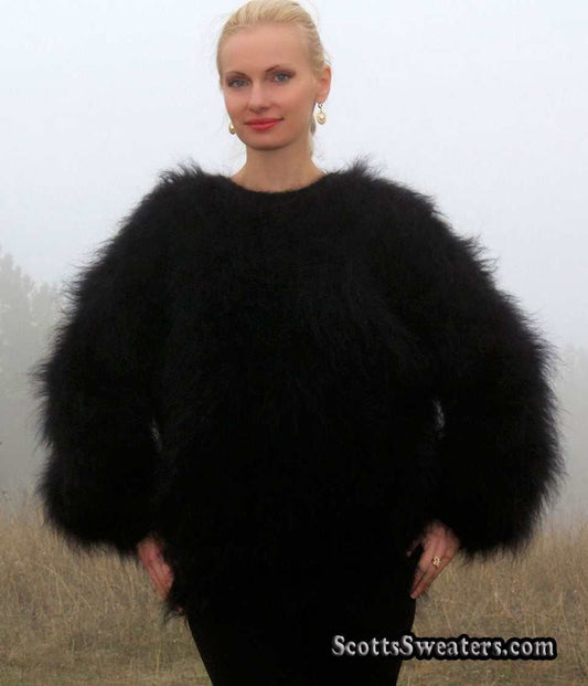 Woman wearing a black very fuzzy mohair sweater with long fibers and round neck, size Large/X-Large