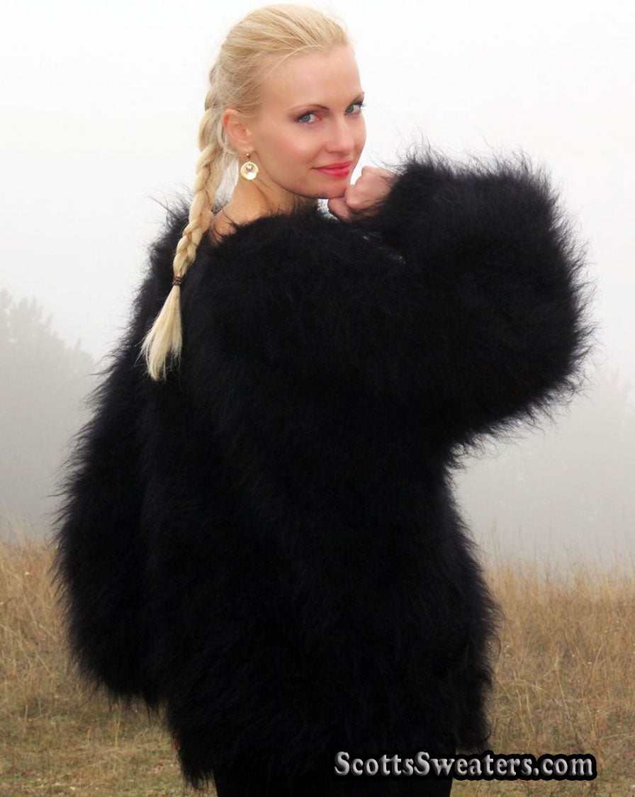 Woman wearing large black very fuzzy mohair sweater with round neck outdoors