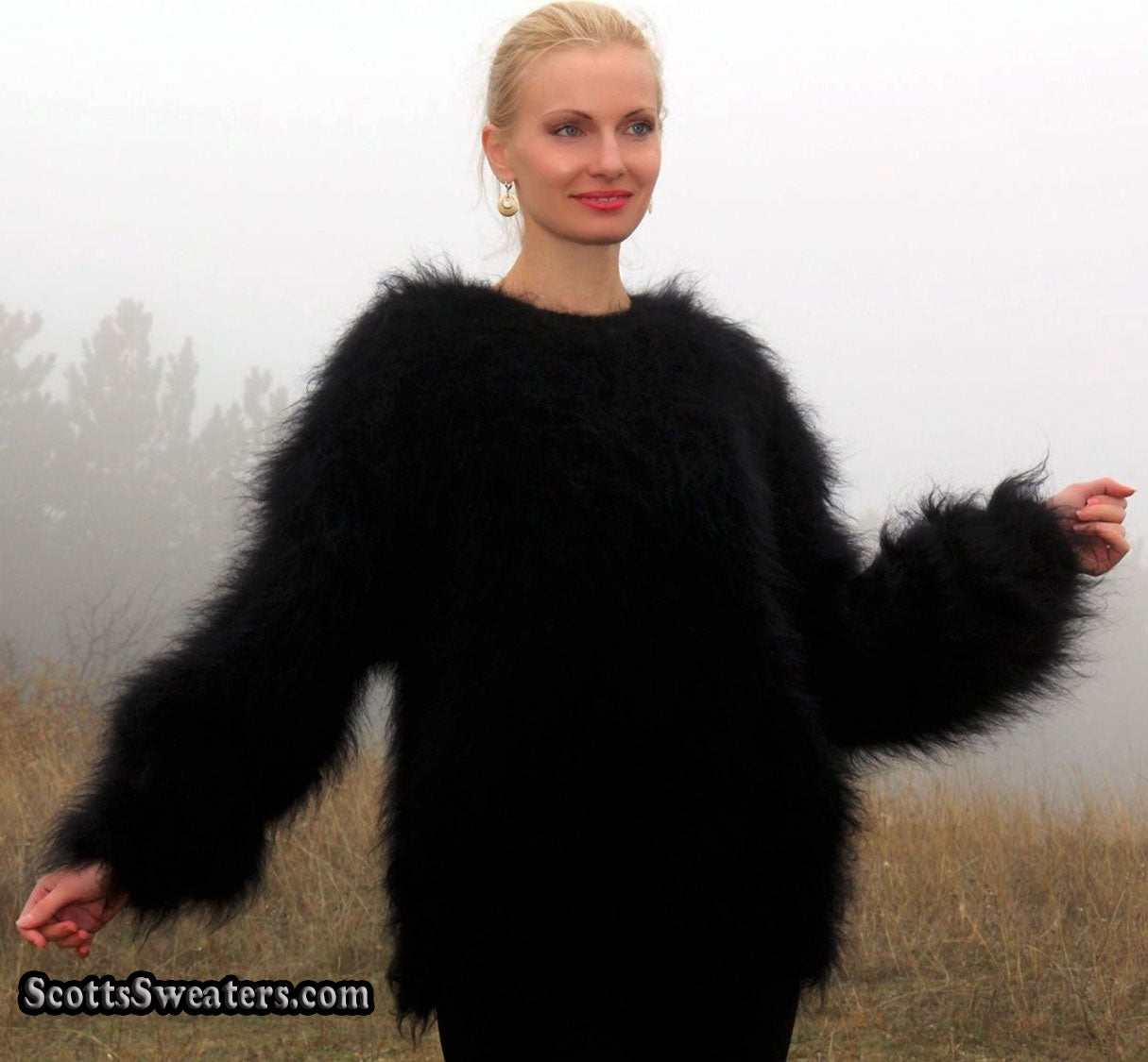 Woman wearing black very fuzzy mohair sweater outdoors in foggy field
