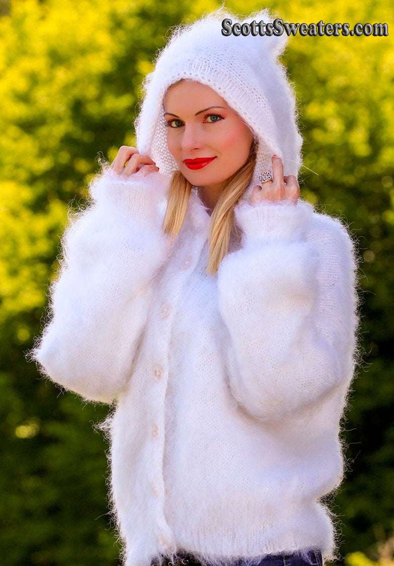 Woman wearing white hand-knit mohair sweater jacket with hood outdoors
