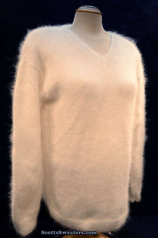 Woman wearing white hand-knit angora sweater by Scott's Sweaters, medium size, V-neck pullover made from home-spun angora yarn