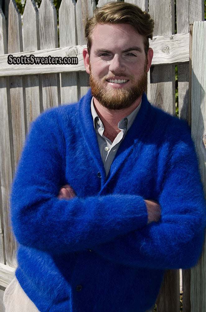 Man wearing royal-blue men's solid-color angora cardigan sweater with shawl-neck collar outdoors