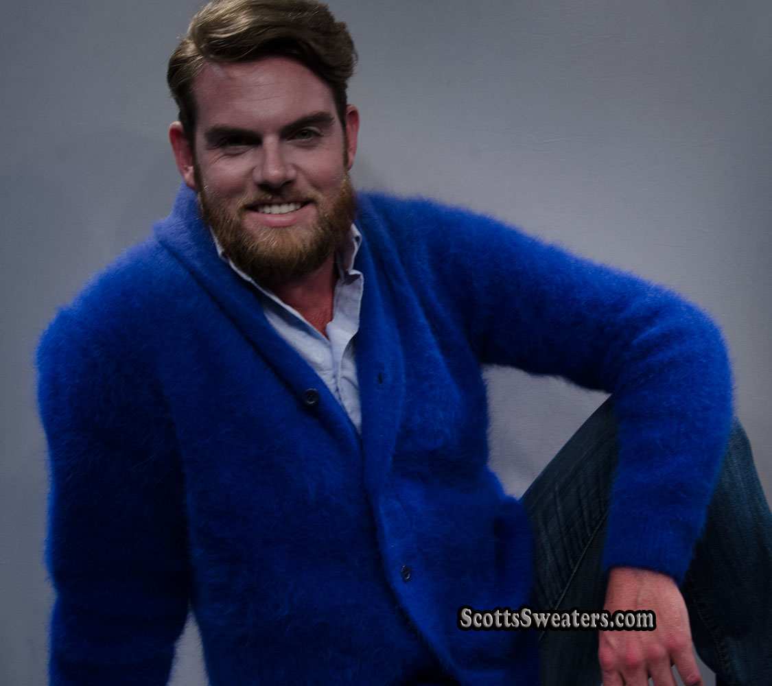 Man wearing a royal blue men's solid-color angora cardigan sweater with shawl-neck collar