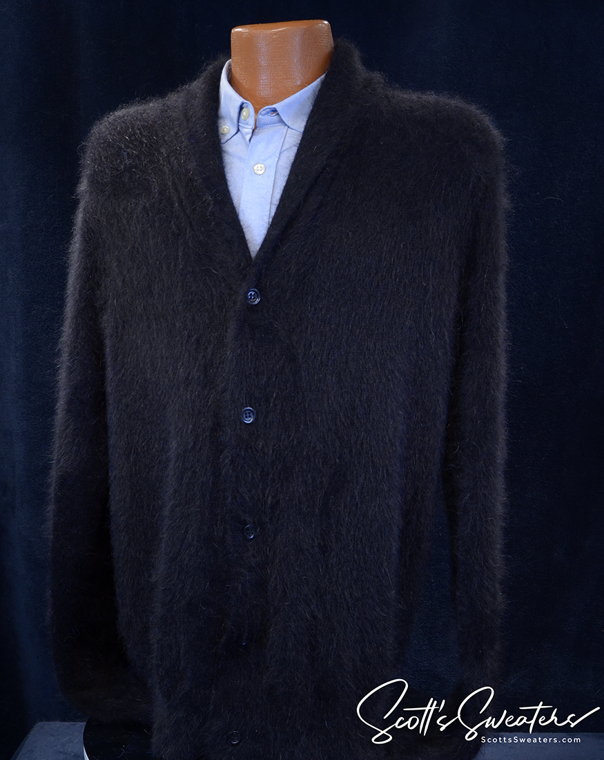Men's black shawl neck angora cardigan sweater displayed on a mannequin over a light blue button-up shirt.