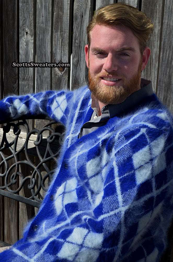 Men's argyle angora cardigan sweater in blue and white three-tone pattern, worn by a seated man outdoors