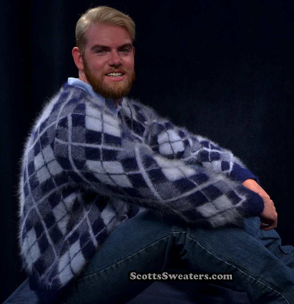 Men's argyle angora cardigan sweater in three-tone pattern worn by smiling man sitting against black background