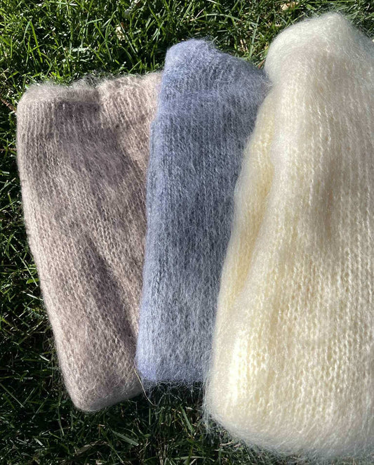 Mens mohair sweater "A Single Man" hand-knit boatneck in beige, blue, and cream colors on grass