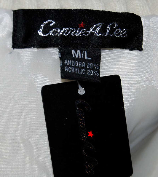 Close-up of Connie A. Lee label and size tag on woman's white angora sweater vest with black hang tag