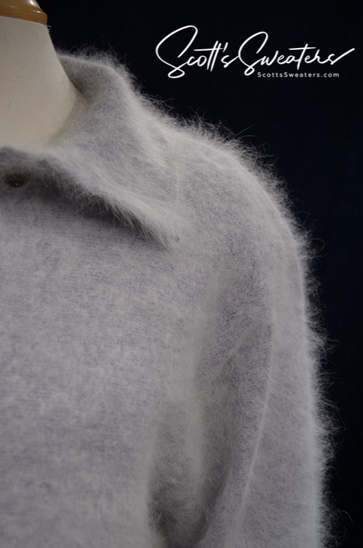 Close-up of a grey woman's angora polo-neck sweater made of soft, fluffy 80% angora wool.