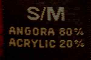 Close-up of size label on Woman's Angora Jewel-neck Sweater showing material composition of 80% angora and 20% acrylic in size Small/Medium