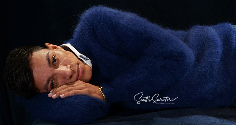 Men's soft luxurious navy blue angora sweater with rib-knit texture and V-neck worn by model lying down