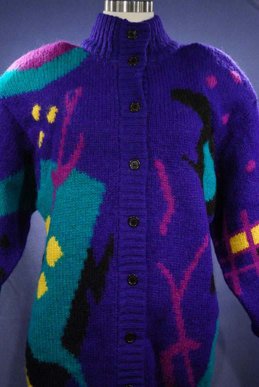 Woman's brightly colored wool sweater-coat with abstract desert motif and button-up front