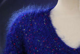 Close-up of woman's blue speckled mohair V-neck sweater with multicolored knit-in specks