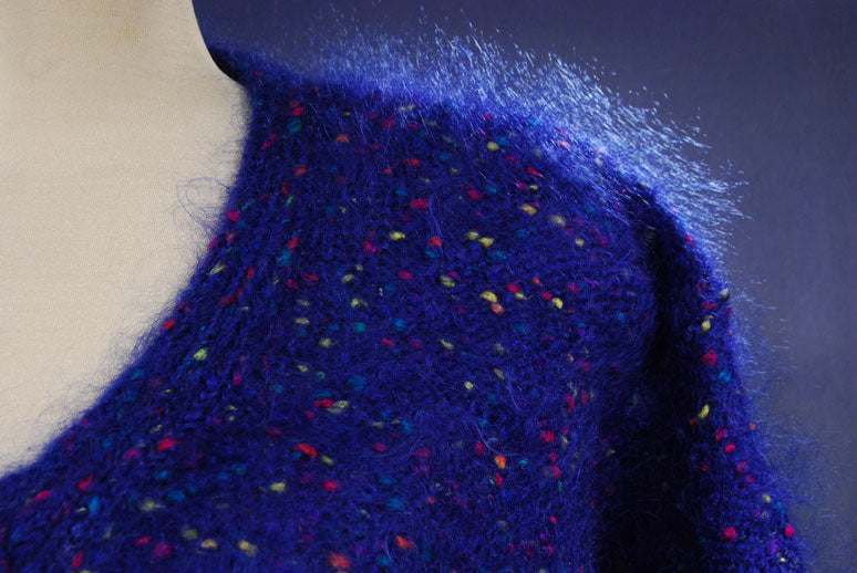 Woman's fuzzy blue mohair V-neck sweater with multicolored specks in red, green, yellow, and blue, small-medium size