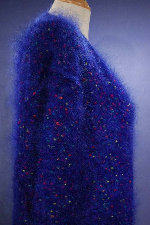 Woman's blue speckled mohair V-neck sweater with colorful knit-in specks on mannequin