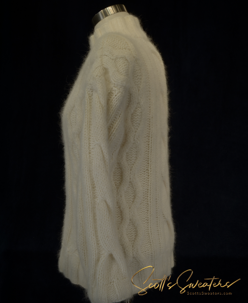 White woman's cabled mock-turtleneck sweater made of angora, lambswool, and nylon blend doux soft knitwear